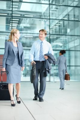 man and woman chatting waiting for shuttle at a Houston Airport